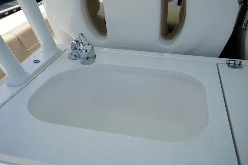 Slide: The Image of 2025 Edgewater 340CC boat seats with integrated sink and storage. - 30