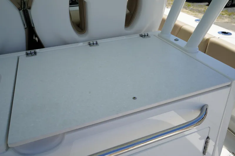 Slide: The Image of 2025 Edgewater 340CC boat roof with rod holders and speakers under clear sky. - 31