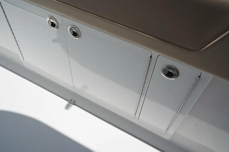 Slide: The Image of 2025 Edgewater 340CC boat deck with storage compartments and seating. - 41
