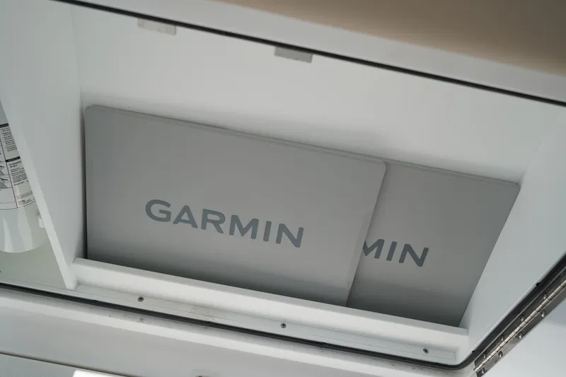 Slide: The Image of 2025 Edgewater 340CC boat interior with storage compartments and seating. - 42