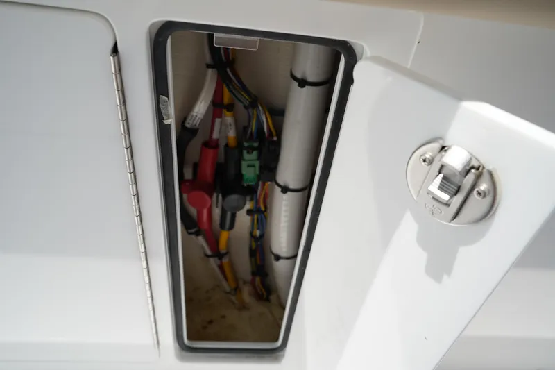 Slide: The Image of 2025 Edgewater 340CC boat storage compartments with beige cushioned seating. - 43