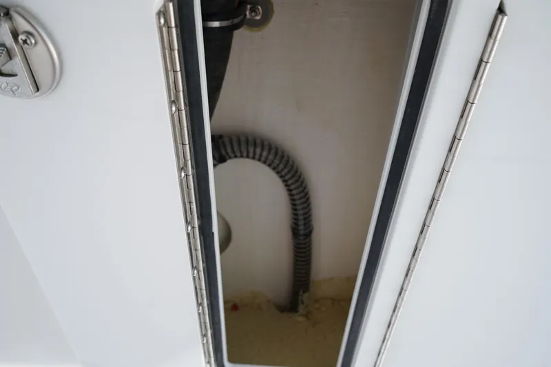 Slide: The Image of 2025 Edgewater 340CC boat deck with stainless steel fixtures and seating. - 48