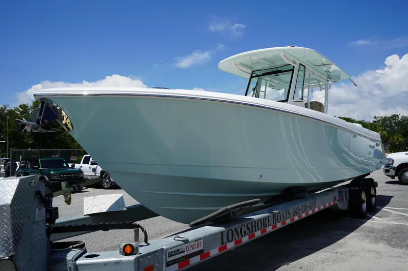 Slide: The Image of 2025 Edgewater 340CC boat on trailer, featuring dual Yamaha outboard engines. - 5
