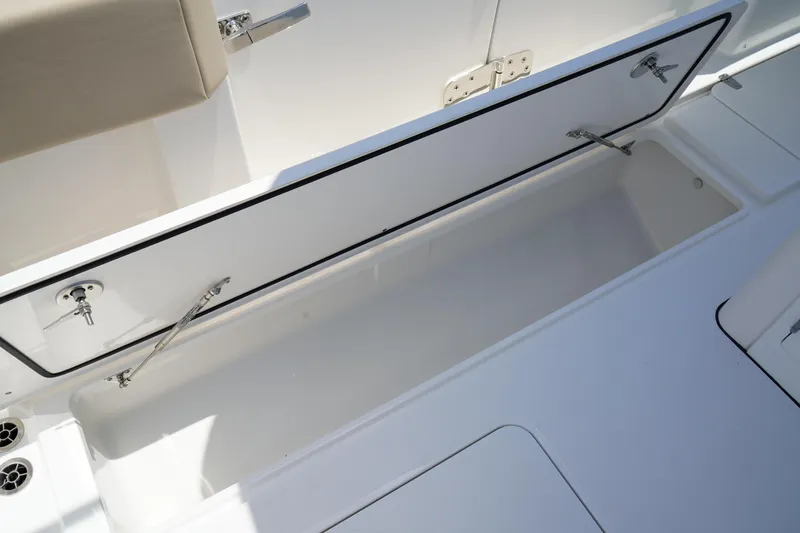Slide: The Image of 2025 Edgewater 340CC boat interior with storage compartments and sleek design. - 50