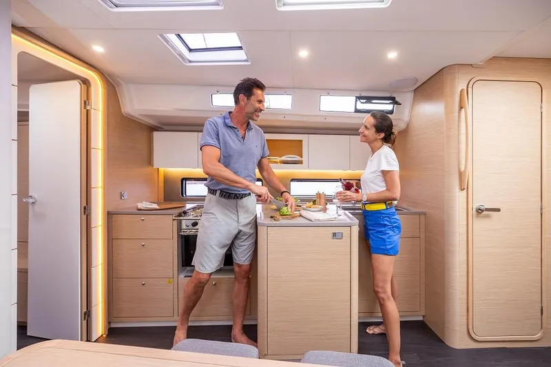 Slide: The Image of Couple enjoying modern kitchen in 2025 Dufour 41 yacht interior. - 10