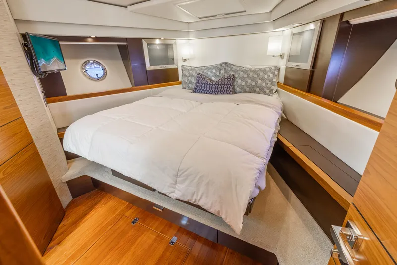 Slide: The Image of Luxurious bedroom interior of 2017 Tiara Yachts 53 Coupe with elegant bedding and wood accents. - 14