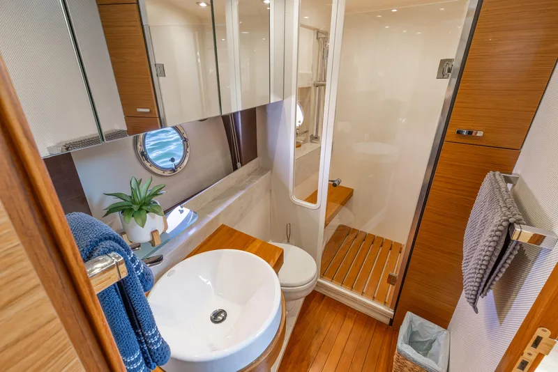 Slide: The Image of Luxurious bathroom in 2017 Tiara Yachts 53 Coupe with modern fixtures and wooden accents. - 17