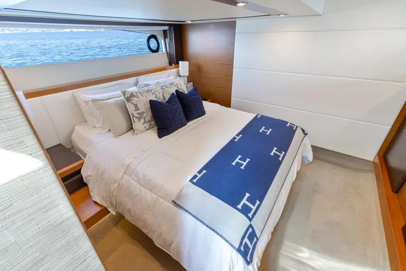 Slide: The Image of Luxurious bedroom interior of 2017 Tiara Yachts 53 Coupe with elegant bedding and ocean view. - 2