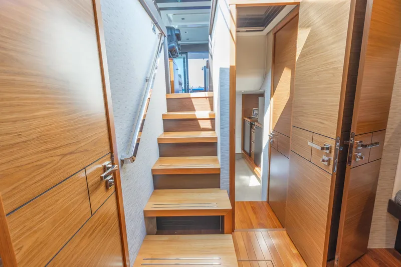 Slide: The Image of Interior of 2017 Tiara Yachts 53 Coupe, featuring wooden stairs and modern design. - 20