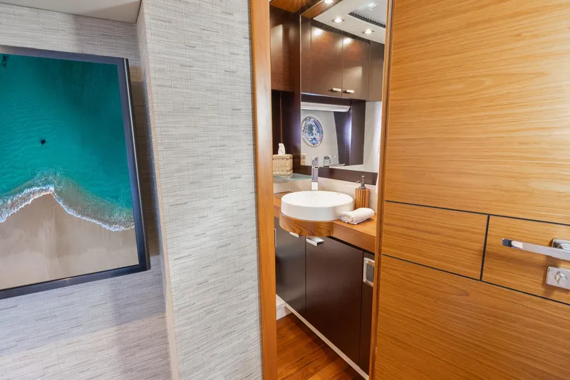 Slide: The Image of Luxurious bathroom interior of 2017 Tiara Yachts 53 Coupe with modern fixtures and artwork. - 24