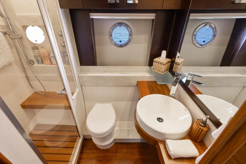 Slide: The Image of Luxurious bathroom in 2017 Tiara Yachts 53 Coupe with modern fixtures and porthole window. - 25