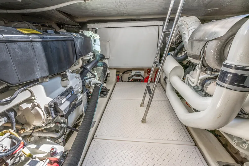 Slide: The Image of Engine room of 2017 Tiara Yachts 53 Coupe with visible machinery and ladder. - 29