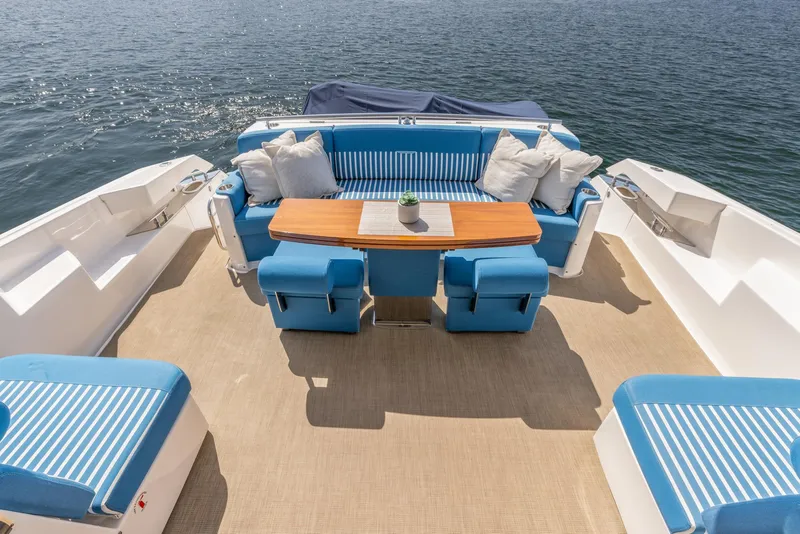 Slide: The Image of 2017 Tiara Yachts 53 Coupe deck with blue seating and wooden table, overlooking water. - 3