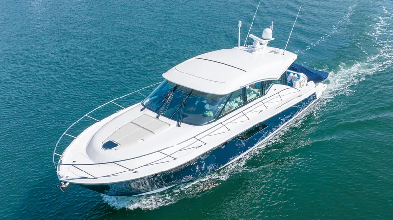 Slide: The Image of 2017 Tiara Yachts 53 Coupe cruising on open water, showcasing sleek design and luxury features. - 33