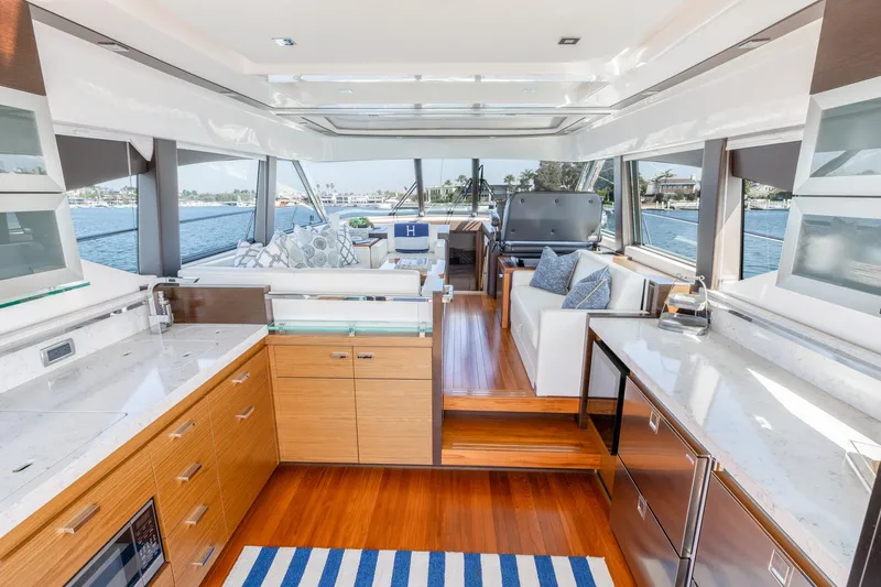 Slide: The Image of Luxurious interior of 2017 Tiara Yachts 53 Coupe with modern kitchen and seating area. - 6