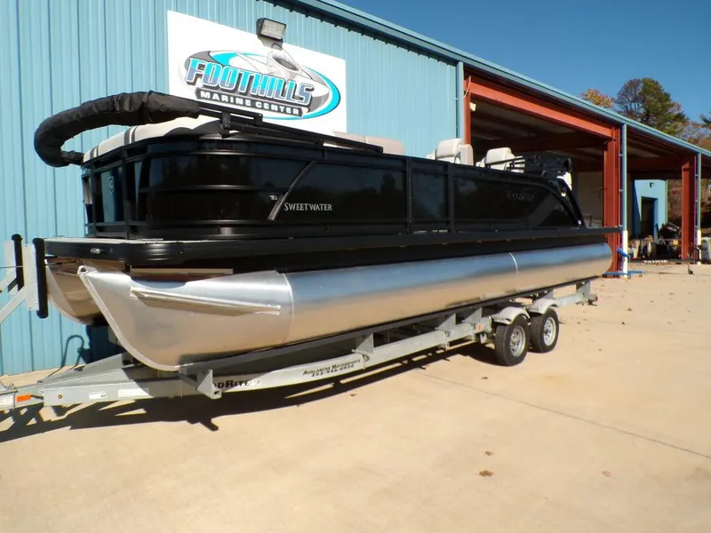 Slide: The Image of 2025 Godfrey Sweetwater 2286 QS pontoon boat on trailer at marine center. - 12