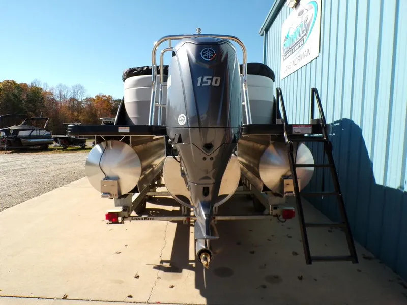 Slide: The Image of 2025 Godfrey Sweetwater 2286 QS pontoon boat with 150 HP engine, parked outdoors. - 13