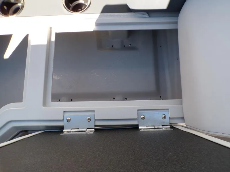 Slide: The Image of Open storage compartment on 2025 Godfrey Sweetwater 2286 QS boat, featuring sturdy hinges. - 25