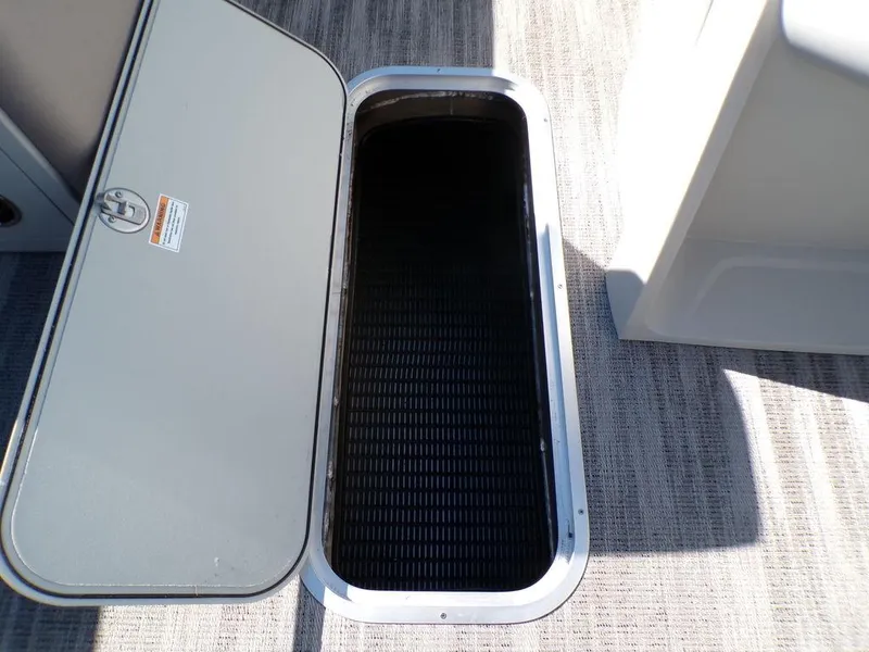 Slide: The Image of Open storage compartment on 2025 Godfrey Sweetwater 2286 QS boat, showcasing interior space. - 29