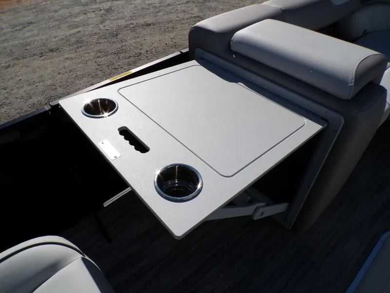 Slide: The Image of 2025 Godfrey Sweetwater 2286 QS boat table with cup holders, gray upholstery. - 30