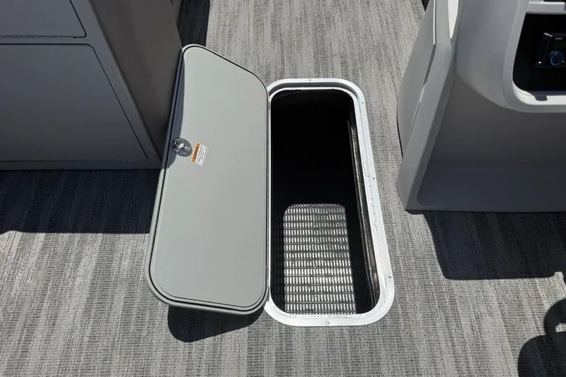 Slide: The Image of Open storage compartment on 2025 Godfrey Sweetwater 2286 QS boat, showcasing interior space. - 42