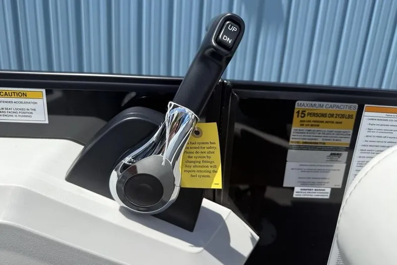Slide: The Image of Throttle control lever on 2025 Godfrey Sweetwater 2286 QS boat, with caution labels visible. - 43