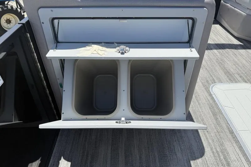Slide: The Image of Storage compartment on 2025 Godfrey Sweetwater 2286 QS boat, featuring dual bins. - 48