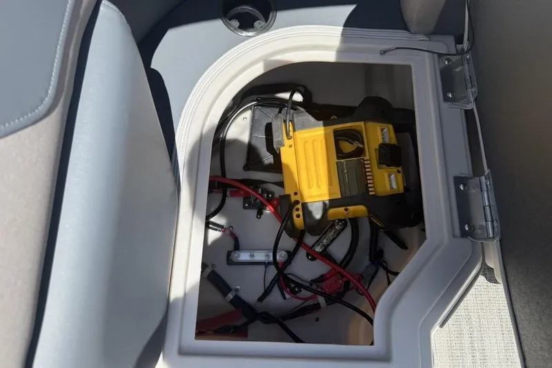 Slide: The Image of Storage compartment with tools and cables on a 2025 Godfrey Sweetwater 2286 QS boat. - 49