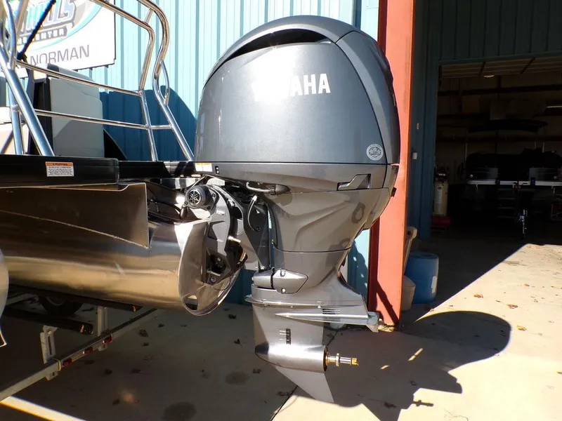 Slide: The Image of Outboard motor on 2025 Godfrey Sweetwater 2286 QS pontoon boat in a garage. - 6