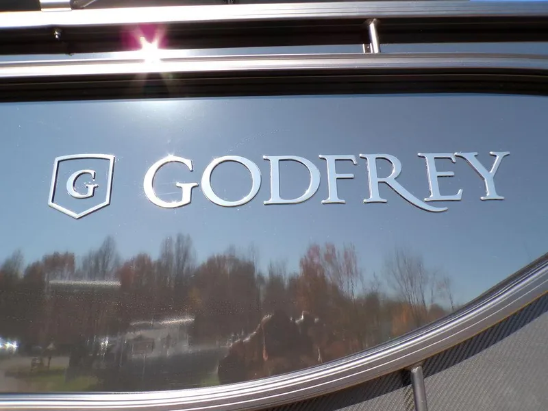 Slide: The Image of Godfrey Sweetwater 2286 QS 27 iMPACT Package logo, 2025 model, reflecting outdoor scenery. - 8