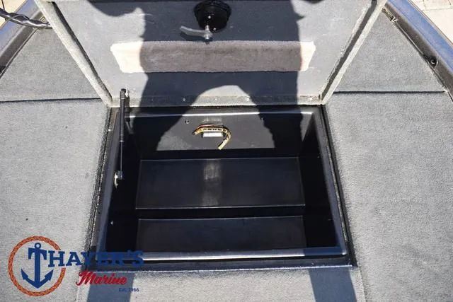 Slide: The Image of 1997 Skeeter ZX202C boat storage compartment with carpeted interior and latch. - 13