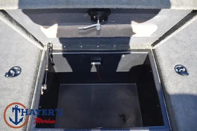 Slide: The Image of Open storage compartment in a 1997 Skeeter ZX202C boat, Thayer's Marine logo visible. - 14