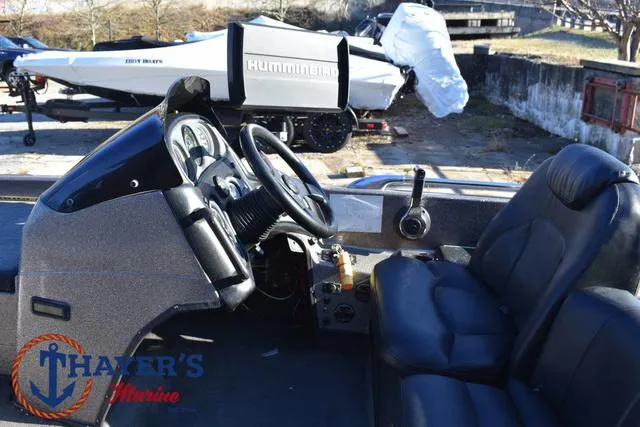 Slide: The Image of 1997 Skeeter ZX202C boat interior with steering wheel and seats, featuring Humminbird equipment. - 23
