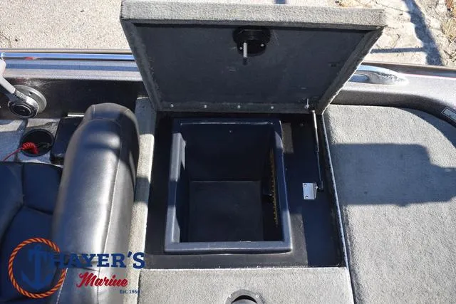 Slide: The Image of 1997 Skeeter ZX202C boat storage compartment with open lid, featuring Thayer's Marine logo. - 27