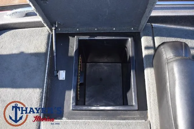 Slide: The Image of 1997 Skeeter ZX202C boat storage compartment, open lid, Thayer's Marine logo visible. - 28