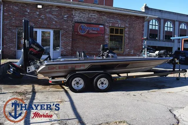 Slide: The Image of 1997 Skeeter ZX202C boat parked outside Thayer's Marine store. - 3