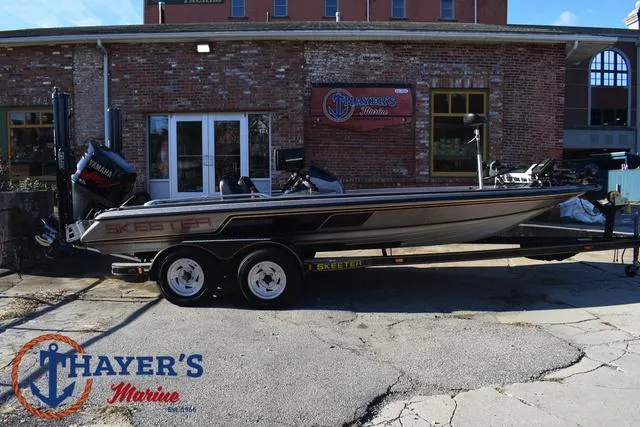 Slide: The Image of 1997 Skeeter ZX202C bass boat on trailer outside Thayer's Marine. - 34