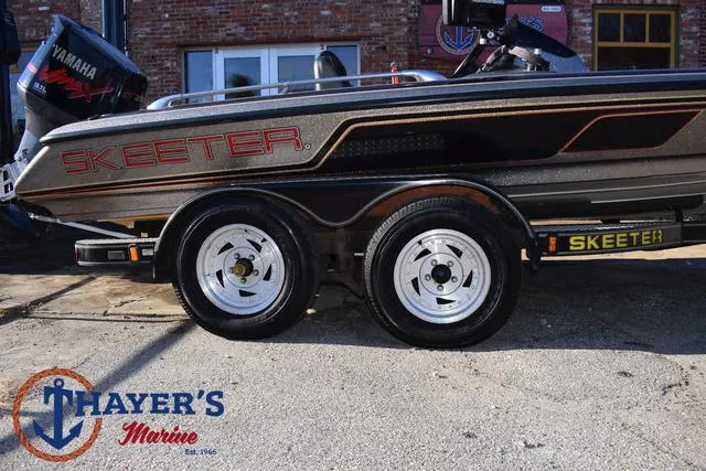 Slide: The Image of 1997 Skeeter ZX202C boat with dual wheels at Thayer's Marine. - 5
