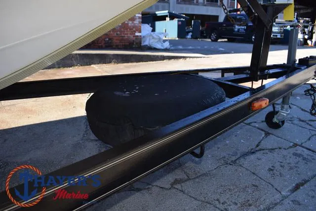 Slide: The Image of 1997 Skeeter ZX202C boat trailer with spare tire, parked on concrete. - 6