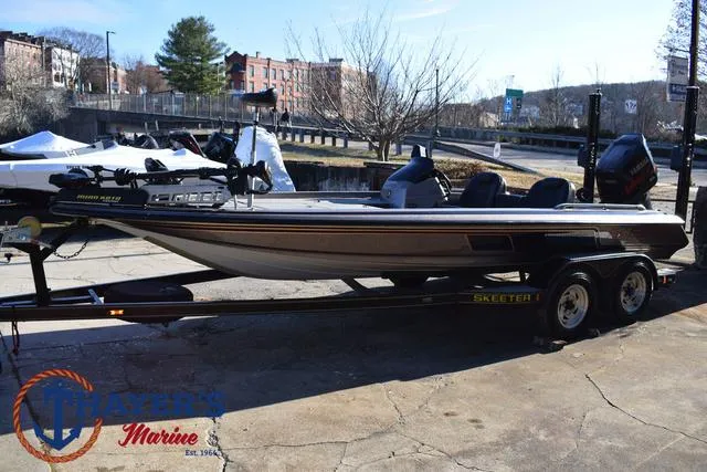 Slide: The Image of 1997 Skeeter ZX202C bass boat on trailer, parked outdoors. - 7
