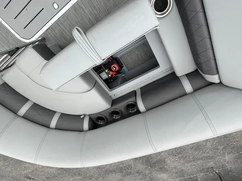 Slide: The Image of 2022 Bennington 23LTFB boat interior with gray seating and storage compartment. - 10