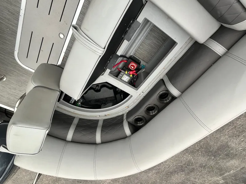 Slide: The Image of 2022 Bennington 23LTFB boat interior with open storage compartment and seating. - 11