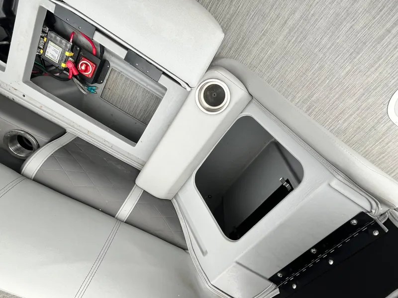 Slide: The Image of 2022 Bennington 23LTFB boat interior with storage compartments and battery access. - 12