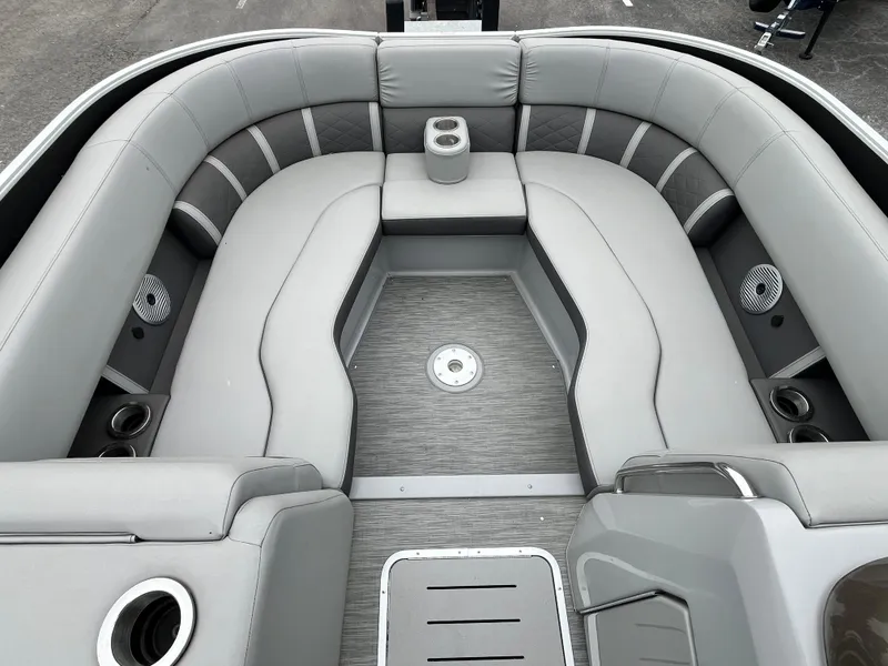 Slide: The Image of 2022 Bennington 23LTFB boat interior with gray seating and cup holders. - 16