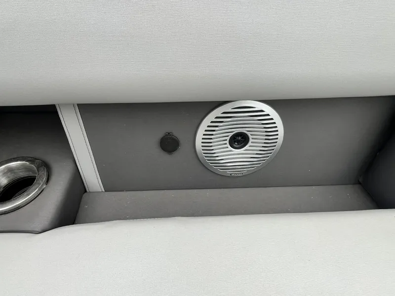 Slide: The Image of 2022 Bennington 23LTFB boat interior with speaker and cup holder. - 23