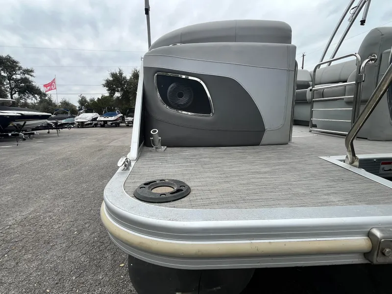 Slide: The Image of 2022 Bennington 23LTFB pontoon boat, rear deck view with seating and speaker. - 24