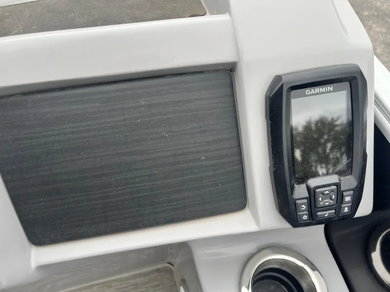 Slide: The Image of Garmin device on 2022 Bennington 23LTFB boat dashboard with cup holder. - 29