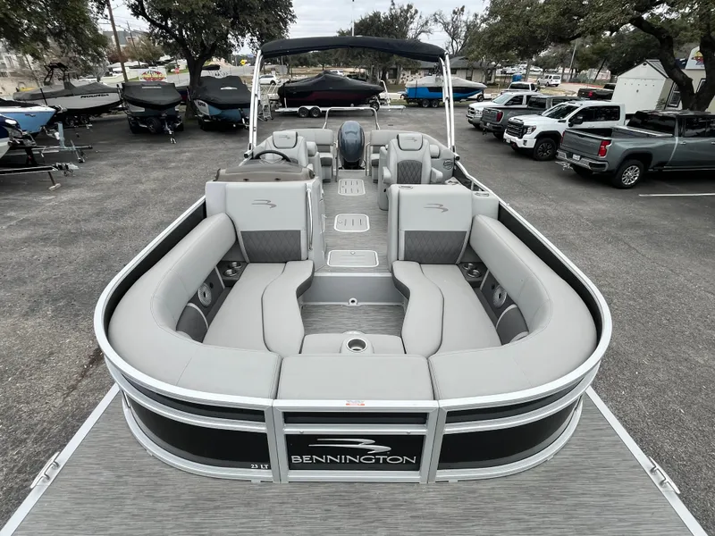 Slide: The Image of 2022 Bennington 23LTFB pontoon boat with spacious seating and sleek design in a marina setting. - 4