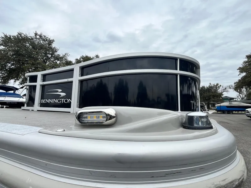 Slide: The Image of 2022 Bennington 23LTFB pontoon boat with sleek black and silver design. - 5