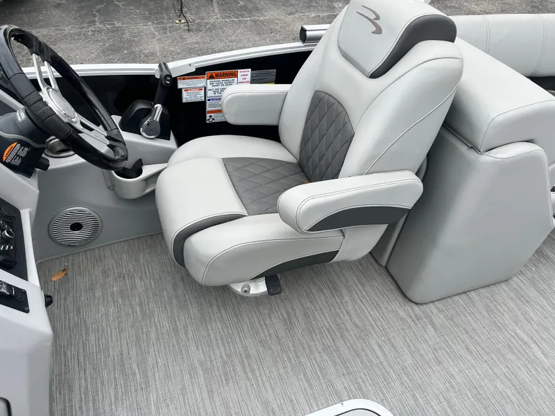 Slide: The Image of Captain's chair in 2022 Bennington 23LTFB boat, featuring gray and black upholstery. - 7